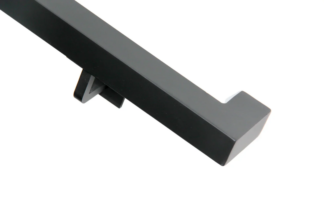 Matte black square steel wall mounted handrail on interior stairs