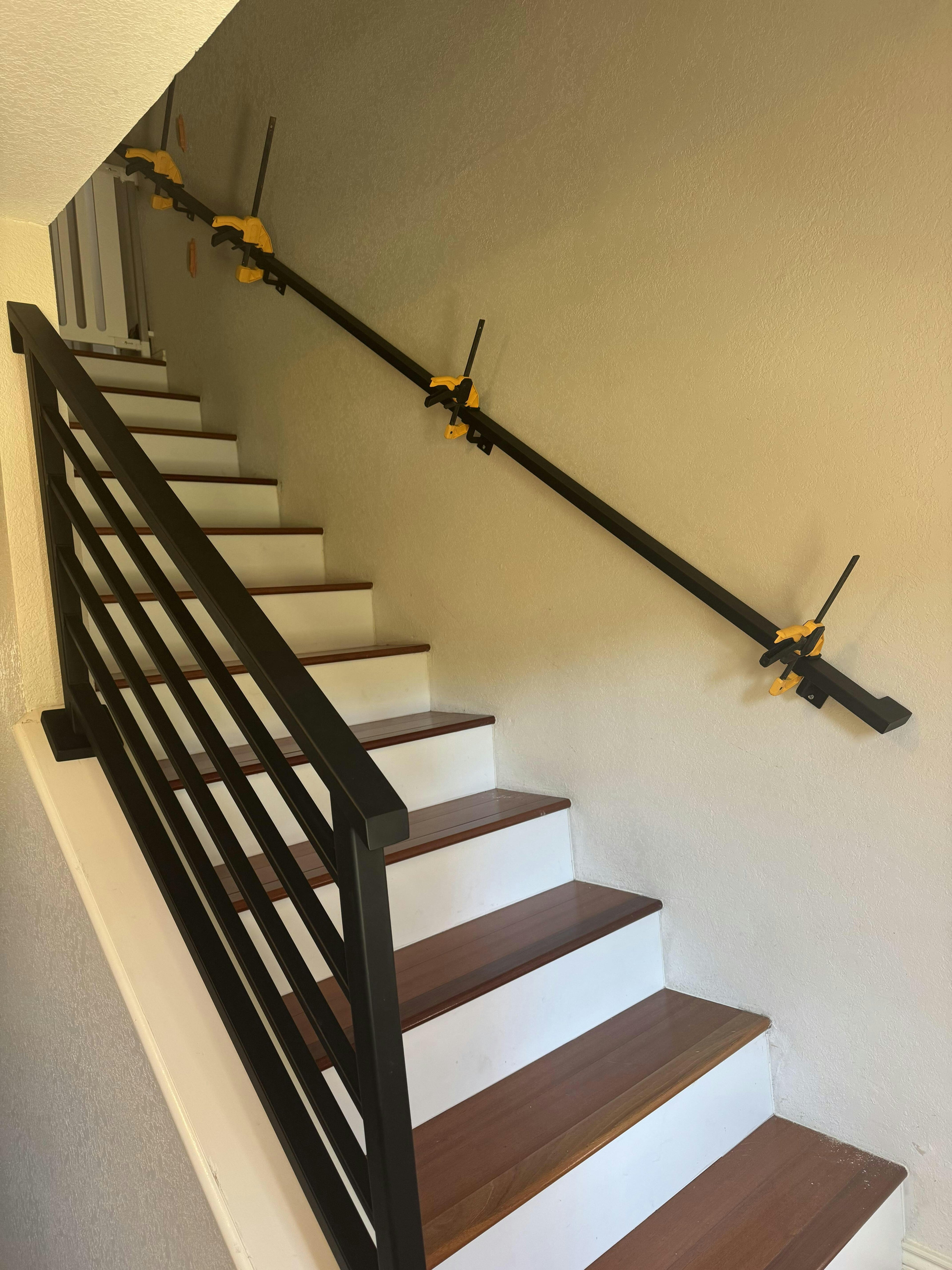 Custom metal stair railing with horizontal bars in a modern home interior