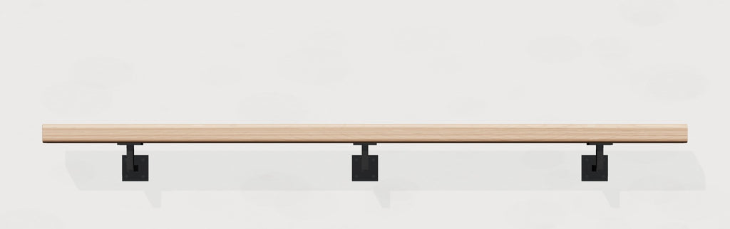 White oak wall handrail on black steel brackets, front view