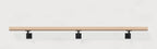 White oak wall handrail on black steel brackets, front view