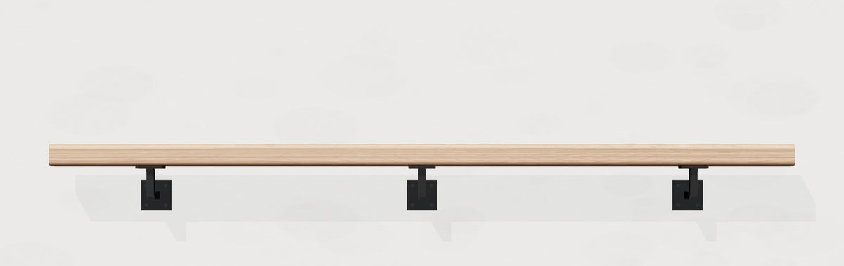 White oak wall handrail on black steel brackets, front view