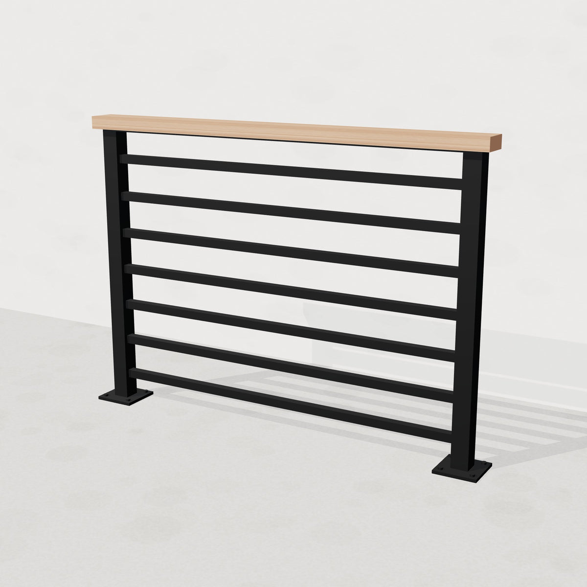 Black steel horizontal stair railing with solid white oak top rail, angled view