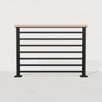 Black steel horizontal stair railing with white oak top rail, front view